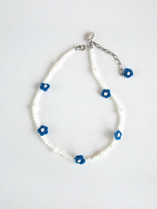 Blue flower with mother-of-pearl necklace