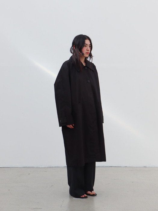 Black oil coating trench coat