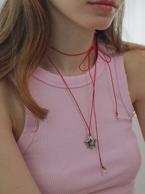Star with red string necklace
